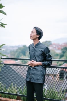 Contemplative young man enjoying peaceful scenery outdoors gazing horizon photo