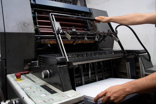 Worker Operating Industrial Printer Professional Printing Process. High quality photo