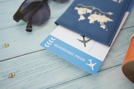 Travel essentials including passport and boarding pass on wooden table photo