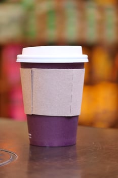 Coffee cup on a table in a cozy cafe ambiance photo