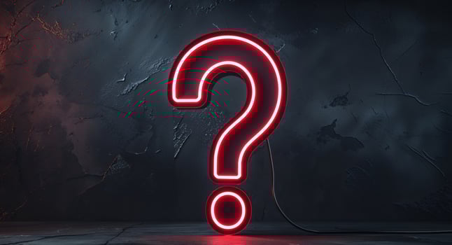 A red neon sign with a question mark on it photo