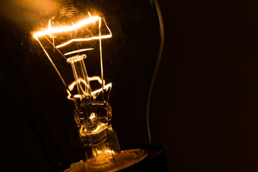 Close-up of electrical bulb on black background photo