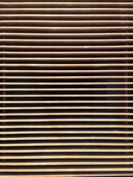 Rusty metal grille creating repeating horizontal lines photo
