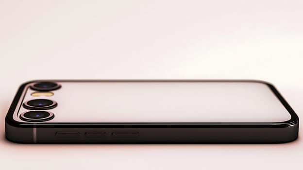 Sleek smartphone resting on a smooth surface, showcasing its design and camera features photo