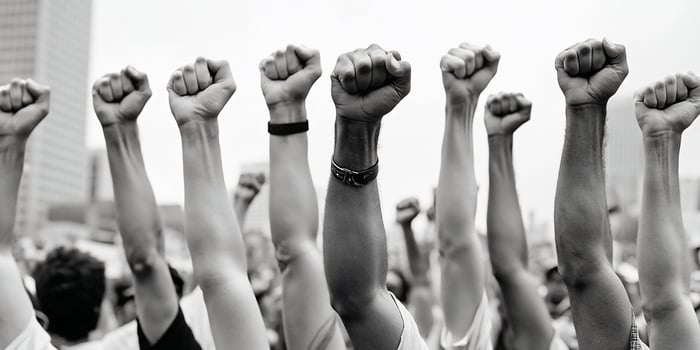 Raised fists symbolize solidarity and protest in a demonstration. photo