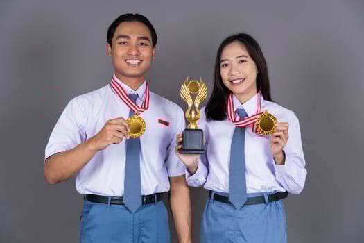 Indonesian Male and Female High School in Uniform Student Achieves Gold Medal Isolated Background photo