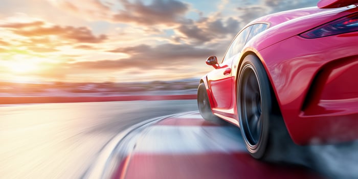 A red sports car driving on a track photo