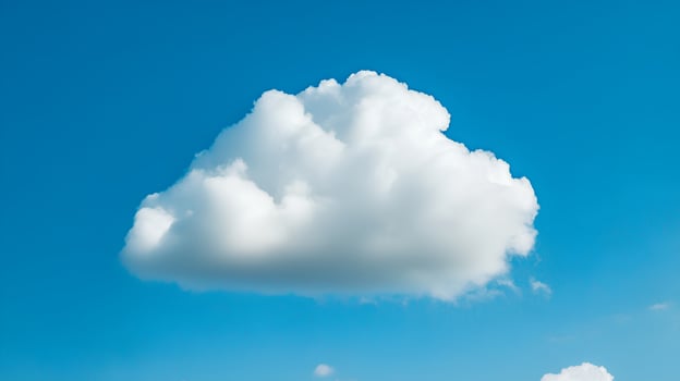 Fluffy White Cloud Against Bright Blue Sky on Sunny Day photo