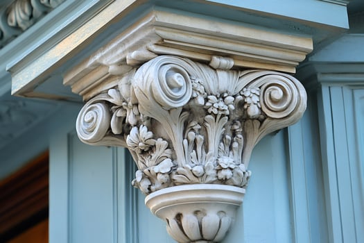 Decorative capital supporting a light blue wooden ledge photo