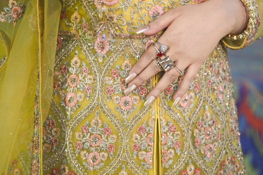 Embroidered ethnic dress with intricate details and jewelry photo
