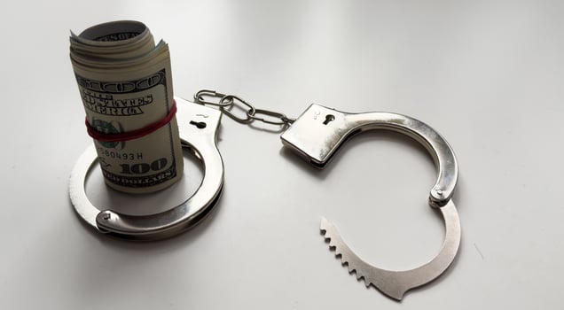 Money and handcuffs isolated on white background photo