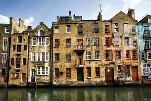 A charming view of historic old houses lining the River Thames in London, UK, showcasing classic architecture and the scenic beauty of the riverside with the citys landmarks in the background. photo