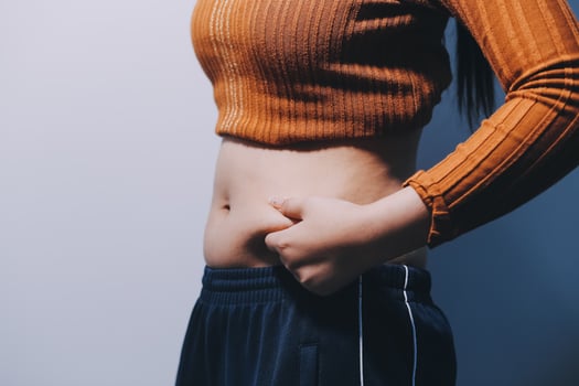 A woman with her hands on her stomach photo