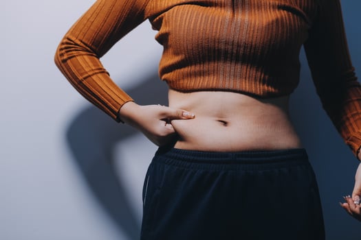 A woman with her stomach exposed photo