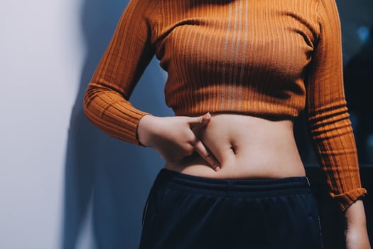 A woman with her hands on her stomach photo