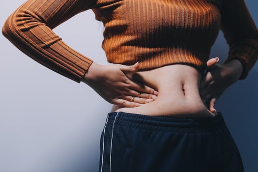 A woman with her hands on her stomach photo