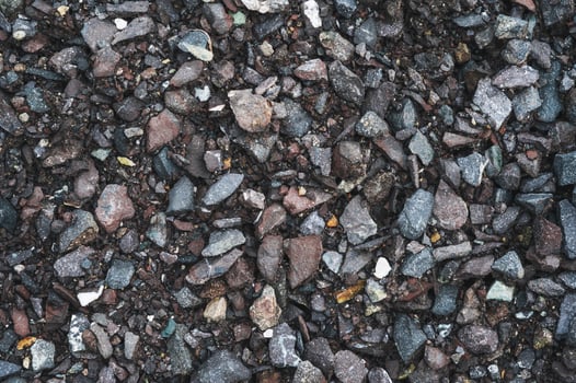 Gray small rocks ground texture. black small road stone background. photo