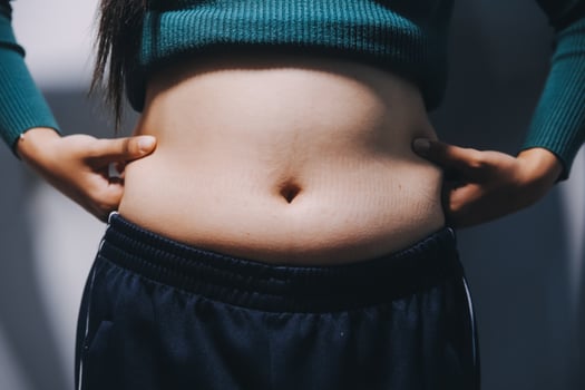 A woman with her hands on her stomach photo