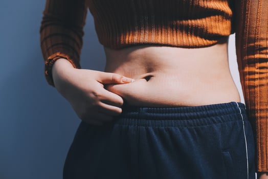 A woman with her stomach showing off her belly photo