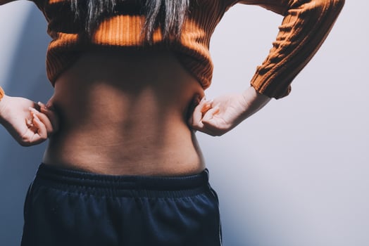 A woman with her hands on her stomach photo