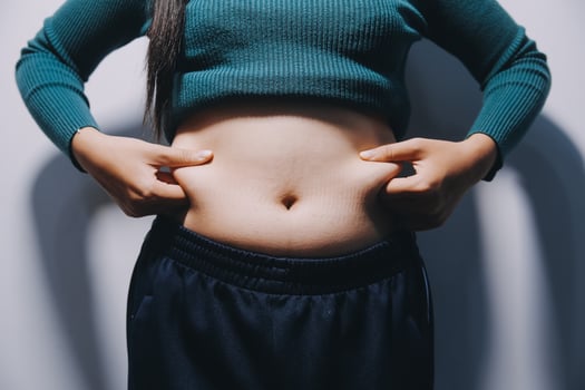 A woman with her hands on her stomach photo