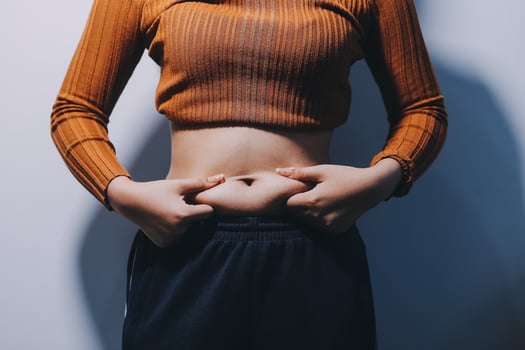 A woman with her hands on her stomach photo