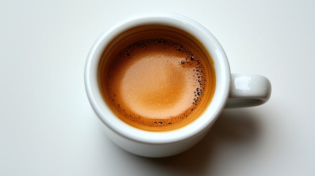 Close-up of a cup of espresso coffee with crema on white background photo
