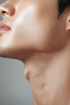 Close-up of a man's jawline and neck with smooth skin photo