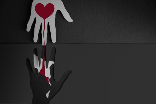 Donation, Helping, Support Concepts. Paper Cut as Hands Shape hanging on the wall. look like the top one Connecting the one below with a Red Heart photo