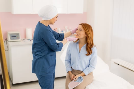 A woman getting her hair done by a doctor photo