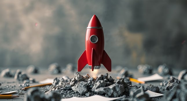 Toy rocket placed on rubble representing creativity and innovation in a startup environment photo
