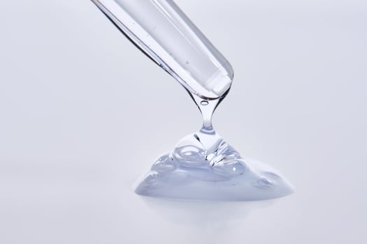 Pipette with delicate blue serum close-up. photo