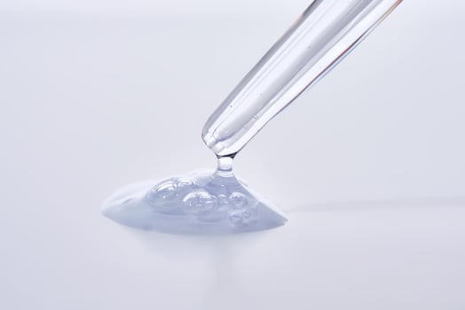 Pipette with delicate blue serum close-up. photo