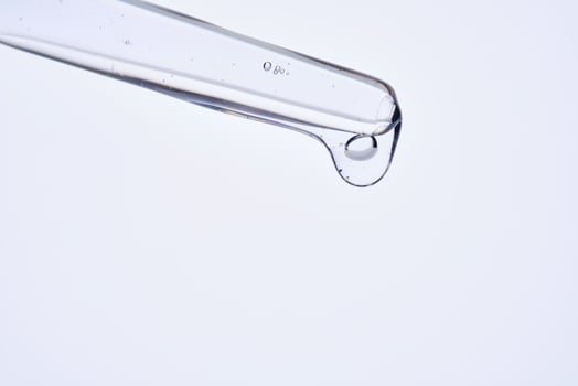 Pipette with delicate blue serum close-up. photo