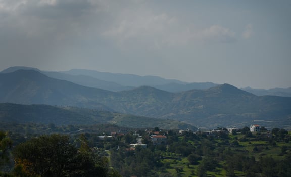 Breathtaking landscape view of mountains with a peaceful village nestled among lush greenery photo