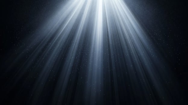 Illuminating rays of light descend from above, casting a celestial glow in a dark space. Streaks create a sense of divine intervention. photo