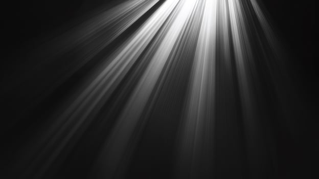 Rays of light stream down in the darkness, illuminating the unseen below. The glow creates ethereal contrast. photo