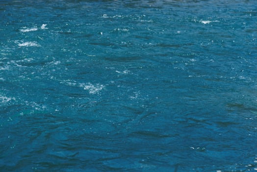 Blue water with ripples on the surface splash photo