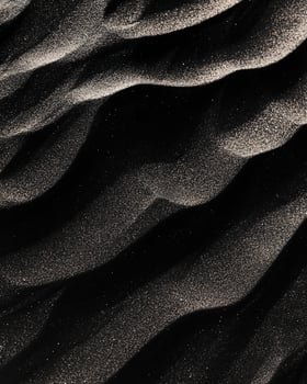 Undulating Dark Sand Texture with Light Grains photo