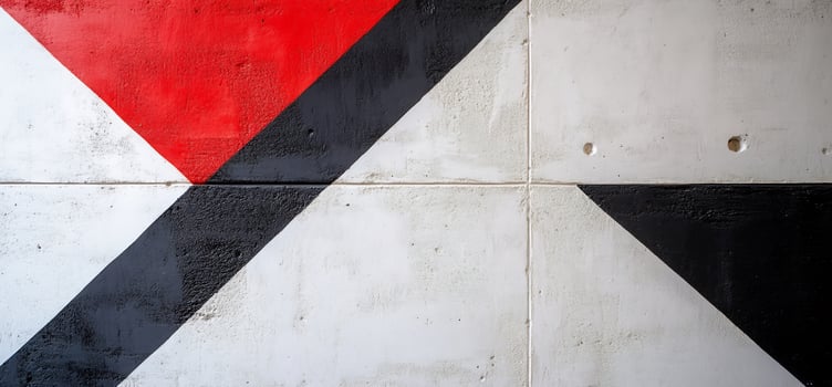 A black, white and red wall with a triangle painted on it photo