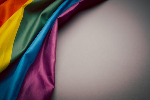 The rainbow flag or LGBTQ flag on a gray background photo