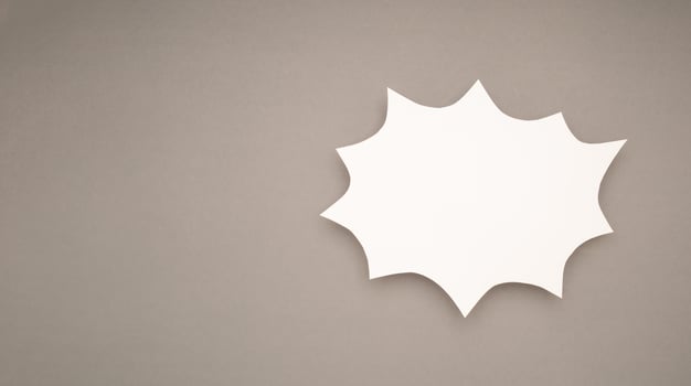 A blank white comic speech bubble on a gray background photo