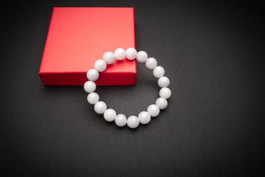White jade bangle or bracelet on a black background photo