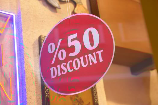 Store offers significant price reduction with 50 percent discount sign photo