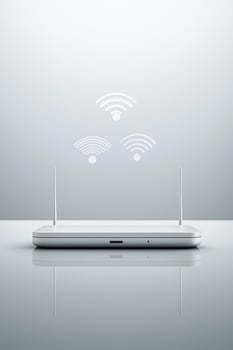 Modern wireless router with wi-fi signal icon representations on gray background photo