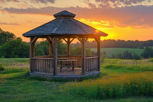 Gazebo overlooking scenic countryside at sunset photo