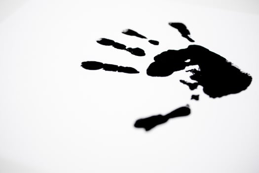 Black handprint on white background symbolizing creativity and expression photo