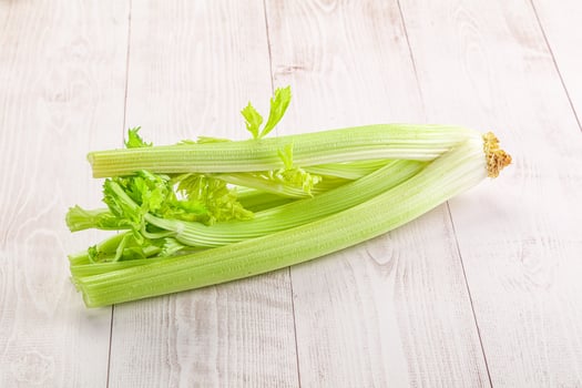 A celery stalk on a white wooden table photo