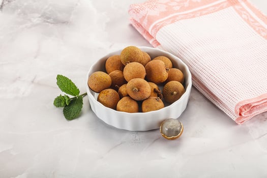 A bowl of nuts and a towel on a marble counter photo