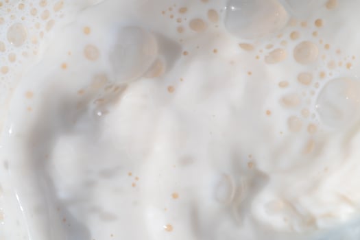 Milk water liquid white color drink and food texture background, Beautiful natural caw milk wave and bubble splash texture with macro on top view, Healthy photo